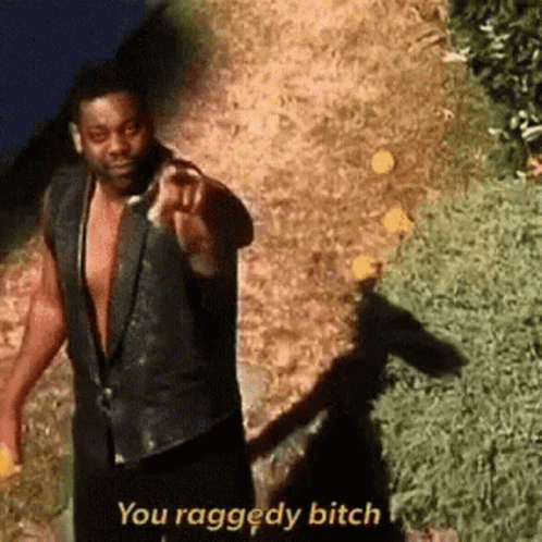 A Man In A Black Vest Is Pointing At The Camera And Saying `` You Raggedy Bitch '' . GIF