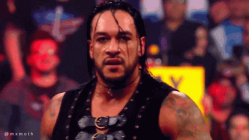 A Man In A Black Vest Stands In Front Of A Crowd With The Hashtag Mxmoth On The Bottom Right GIF