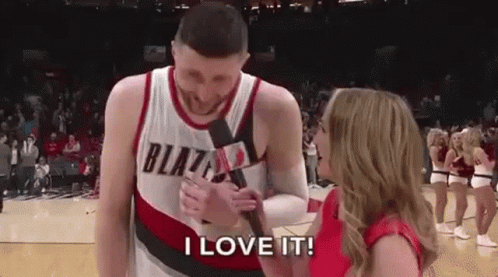 A Man In A Blazers Jersey Is Being Interviewed By A Woman Holding A Microphone . GIF