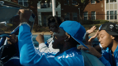 A Man In A Blue Adidas Jacket Is Driving A Convertible GIF