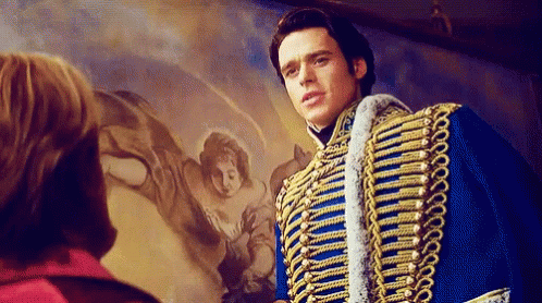 a man in a blue and gold military uniform is standing in front of a painting of a woman .