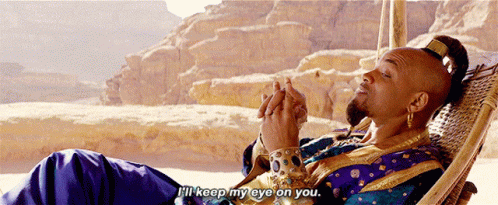 A Man In A Blue And Gold Outfit Is Laying In A Hammock And Says " I 'Ll Keep My Eye On You " GIF