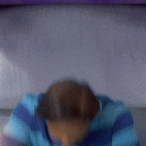 A Man In A Blue And Purple Striped Shirt Is Making A Funny Face And Says I Was Just Having GIF