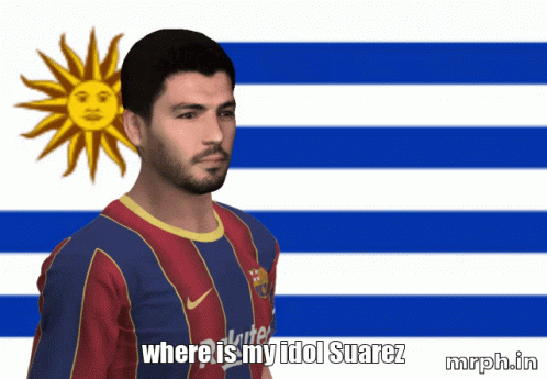 A Man In A Blue And Red Shirt Stands In Front Of A Blue And White Flag GIF