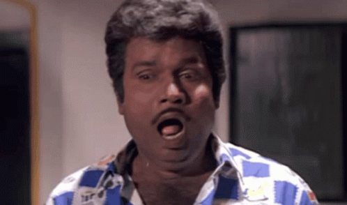 A Man In A Blue And White Checkered Shirt Making A Funny Face GIF