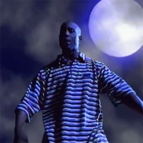 A Man In A Blue And White Striped Shirt Is Dancing In Front Of A Blue Moon . GIF