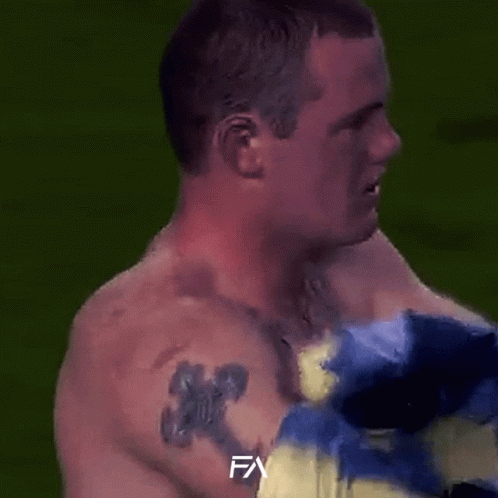 A Man In A Blue And Yellow Striped Shirt With The Letter Fa On The Bottom Right GIF