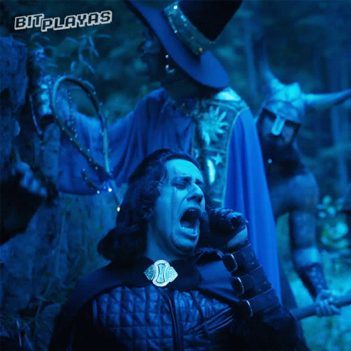 a man in a blue cape stands next to a man in a black hat with the words bitplayas on the bottom right