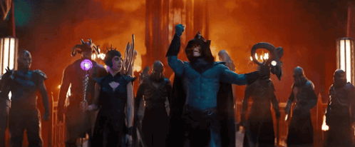 A Man In A Blue Costume Is Holding A Purple Object GIF