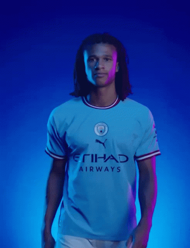 A Man In A Blue Etihad Airways Shirt GIF
