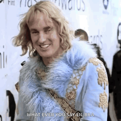 a man in a blue fur coat is smiling and saying what ever you say lil bra