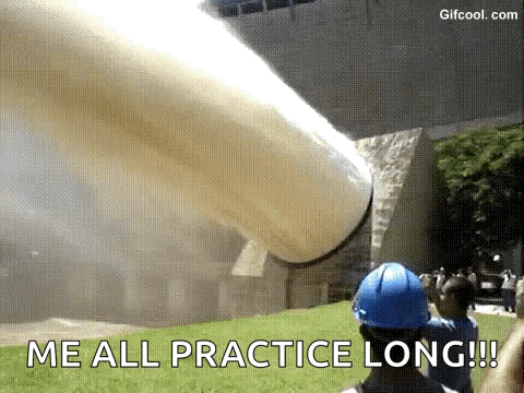 A Man In A Blue Hard Hat Is Standing In Front Of A Large Pipe That Is Blowing Smoke . GIF