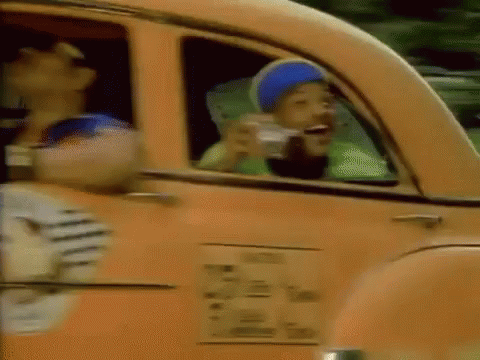 A Man In A Blue Hat Is Drinking From A Cup While Sitting In A Car . GIF