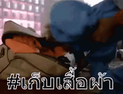 A Man In A Blue Hat Is Laying On A Bed With A Bag On His Head . GIF