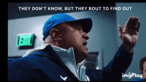 A Man In A Blue Hat Says They Don 'T Know But They Bout To Find Out In Front Of An Exit Sign GIF