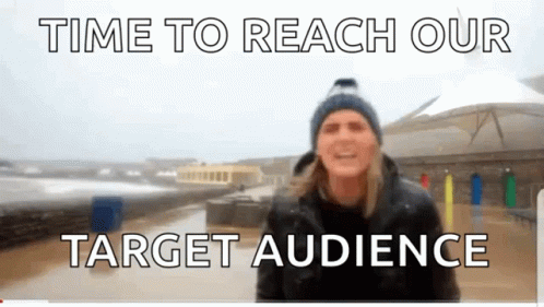 A Man In A Blue Hat Stands In Front Of A Sign That Says " Time To Reach Our Target Audience " GIF