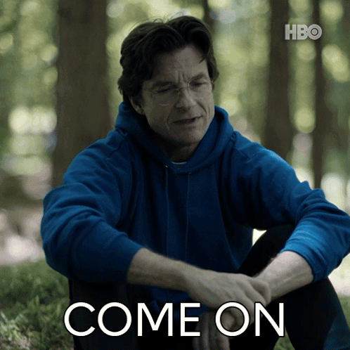 A Man In A Blue Hoodie Is Sitting In The Grass With The Words Come On Written Below Him GIF