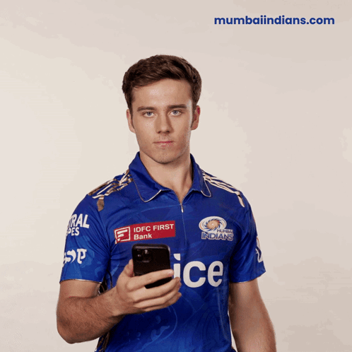 A Man In A Blue Ice Jersey Holds A Cellphone GIF