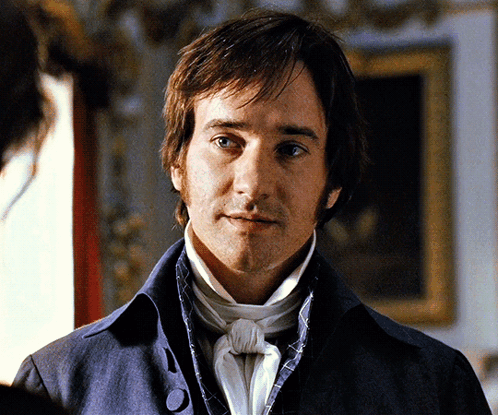 A Man In A Blue Jacket And White Tie GIF