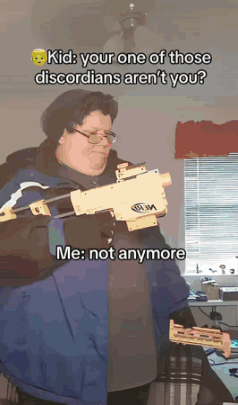 A Man In A Blue Jacket Holds A Nerf Gun GIF