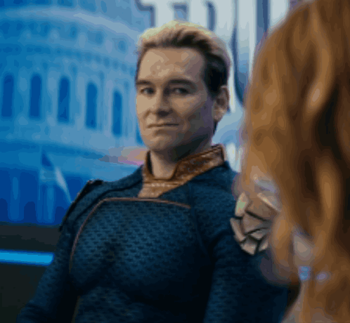 A Man In A Blue Jacket Is Looking At A Woman In Front Of A Building GIF