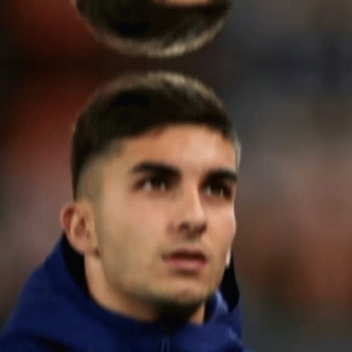A Man In A Blue Jacket Is Looking Up At Something GIF