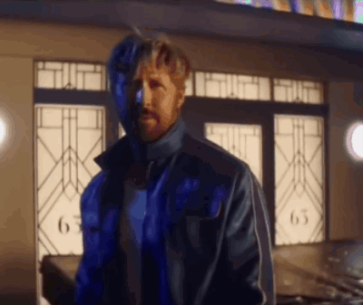 A Man In A Blue Jacket Is Standing In Front Of A Building With The Number 63 On It GIF