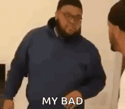 A Man In A Blue Jacket Is Standing Next To Another Man In A White Shirt And Says `` My Bad '' . GIF