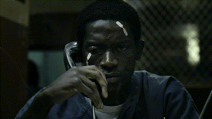 A Man In A Blue Jacket Is Talking On A Telephone GIF