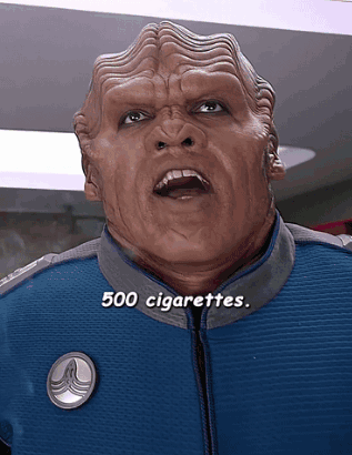 A Man In A Blue Jacket With The Words 500 Cigarettes Written Below Him GIF