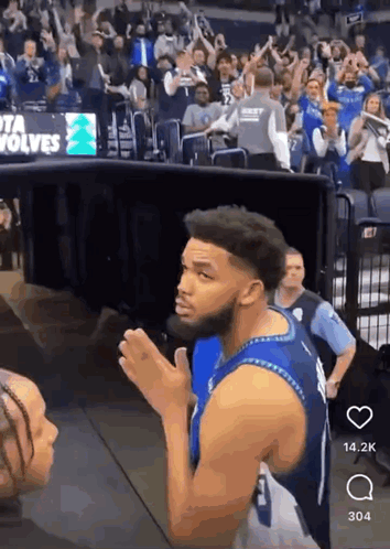 A Man In A Blue Jersey With The Number 1 On It Stands In Front Of A Crowd GIF