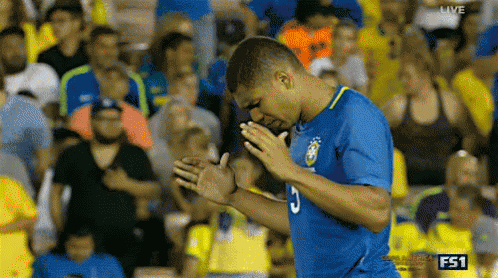 a man in a blue jersey with the number 3 on it prays