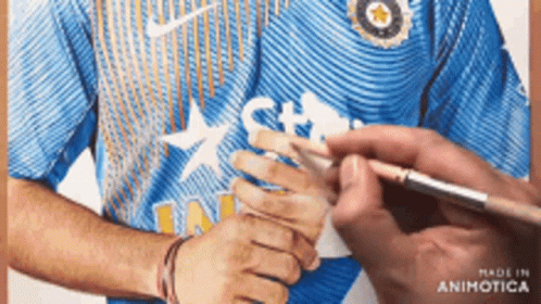 A Man In A Blue Nike Shirt Is Being Painted By Someone GIF