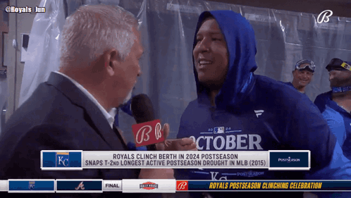 A Man In A Blue October Shirt Is Being Interviewed By A Man In A Suit GIF