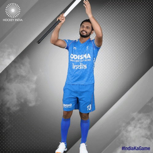 A Man In A Blue Odisha Jersey Holds Up A Hockey Stick GIF