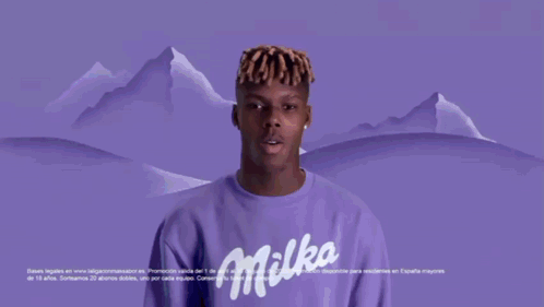 a man in a blue oreo shirt is holding a bar of oreo