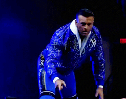 A Man In A Blue Paisley Jacket Is Giving A Thumbs Up GIF