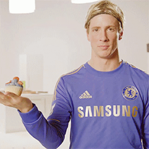 A Man In A Blue Samsung Shirt Holds A Cupcake GIF