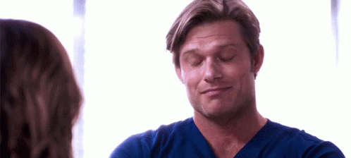Man In Blue Scrub Top Looking At Woman GIF