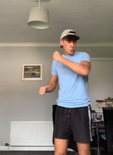 Man In Blue Shirt And Black Shorts Dancing GIF