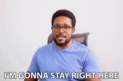 A Man In A Blue Shirt And Glasses Says I 'M Gonna Stay Right Here GIF