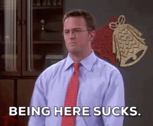 A Man In A Blue Shirt And Red Tie Is Saying Being Here Sucks GIF