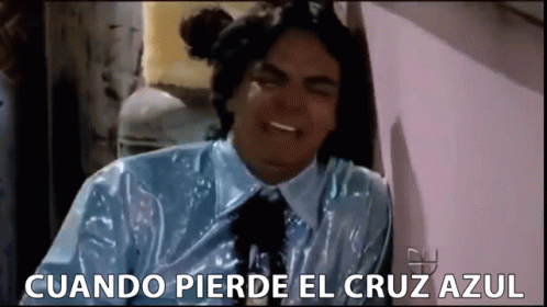 A Man In A Blue Shirt And Tie Is Crying With The Words Cuando Pierde El Cruz Azul Below Him GIF