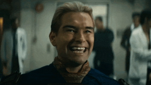 a man in a blue shirt and tie is laughing in a room with other people .