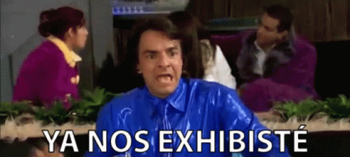 A Man In A Blue Shirt And Tie Is Making A Funny Face And Says Ya Nos Exhibiste GIF