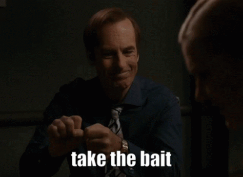 A Man In A Blue Shirt And Tie Is Smiling And Saying Take The Bait GIF