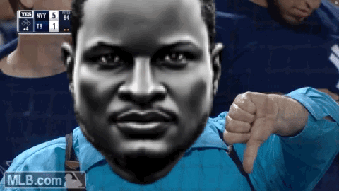 a man in a blue shirt gives a thumbs down sign