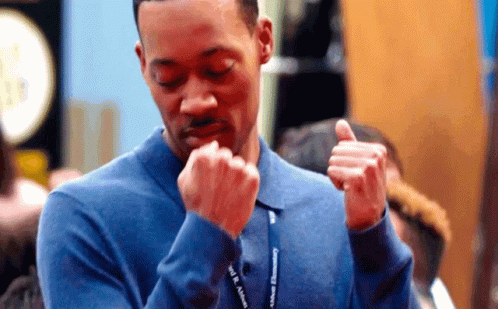 A Man In A Blue Shirt Has A Lanyard Around His Neck That Says " Will Smith " On It GIF