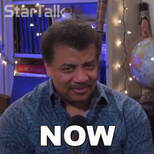 A Man In A Blue Shirt Has The Word Now On His Chest GIF