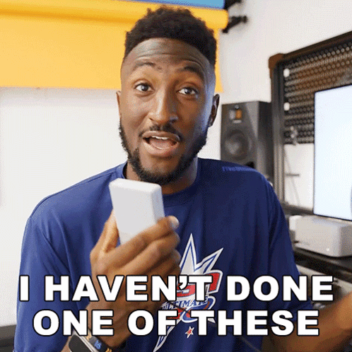 A Man In A Blue Shirt Holds A Cell Phone And Says I Haven 'T Done One Of These GIF
